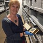 Woman in museum collection store showing and object